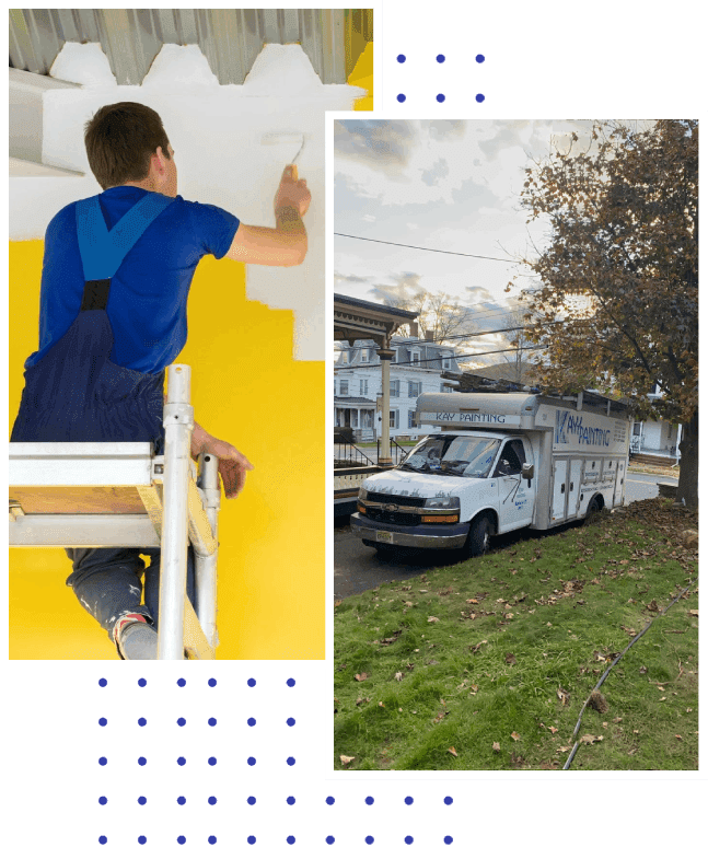 A boy painting the wall of his house and a truck parked in front of it.