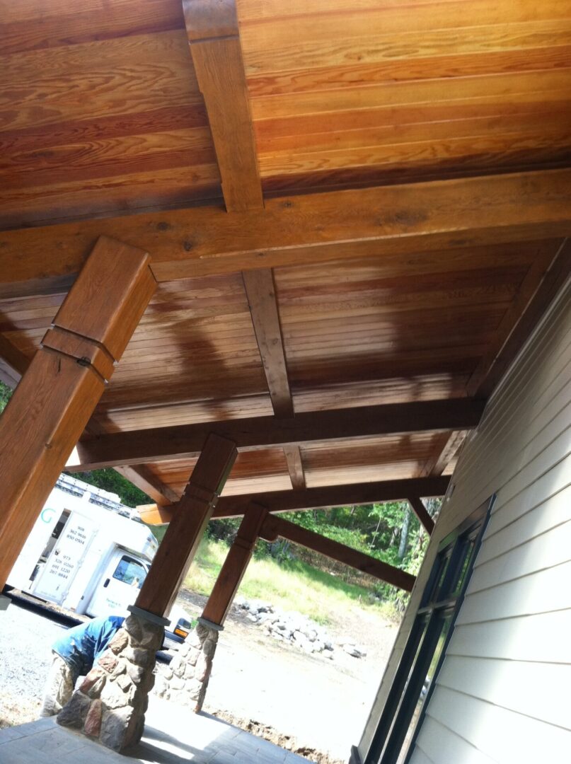 A wooden ceiling in the middle of a porch.