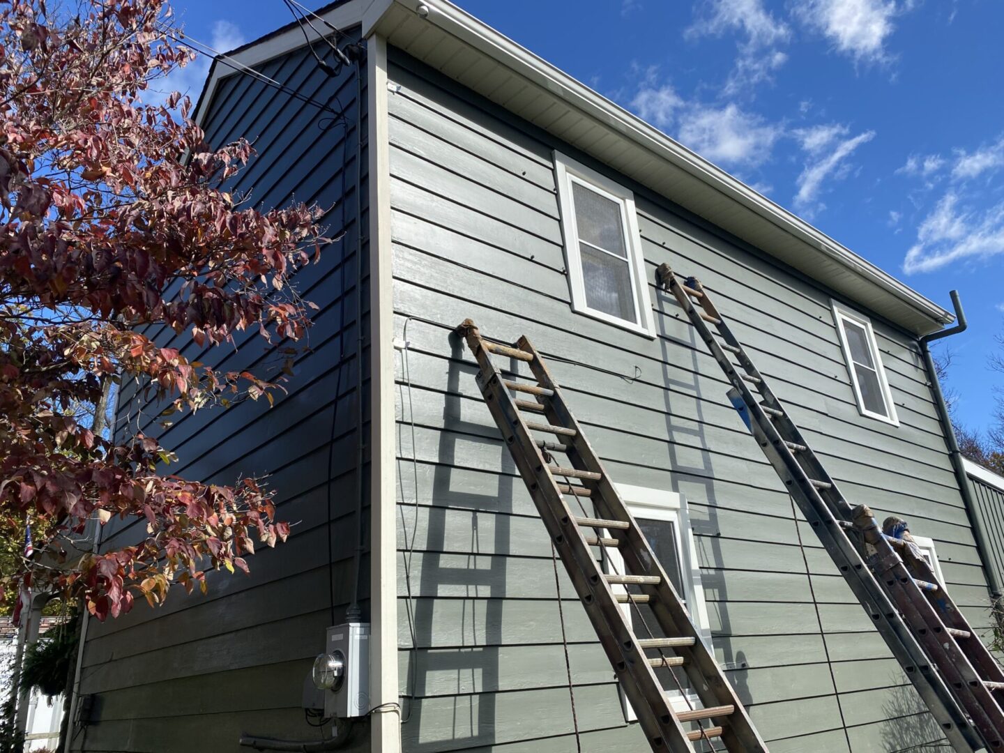 A ladder is attached to the side of a house.